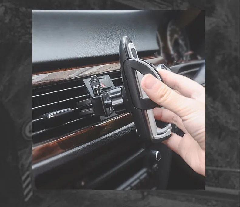 Black plastic car mobile phone holder mounted on vehicle air conditioning outlet