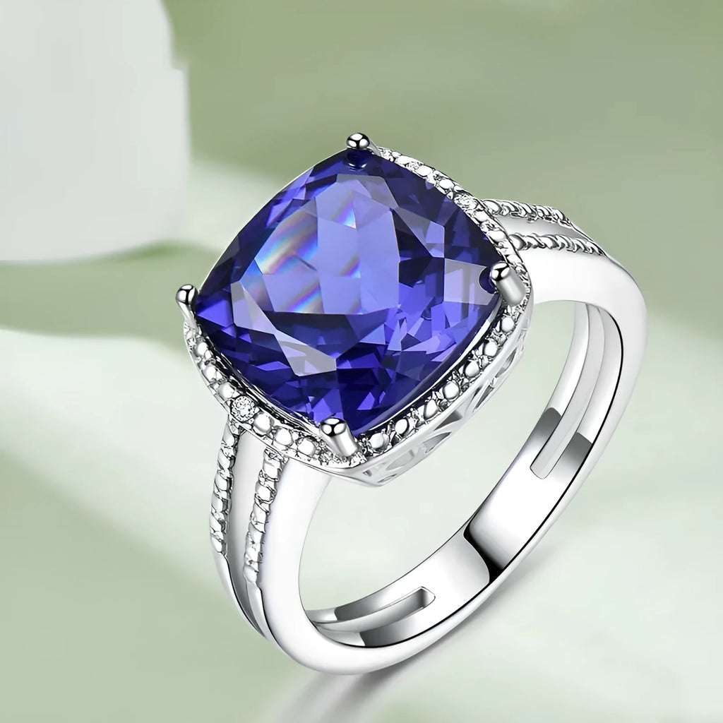 Women's sterling silver ring with a blue tanzanite gemstone on a polished band.
