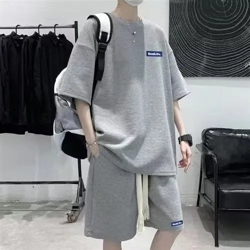A waffle-textured leisure sports suit consisting of a short-sleeve top and shorts, shown in blue.