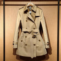 Khaki double-breasted trench coat for women with flight sleeves, shown on a hanger.