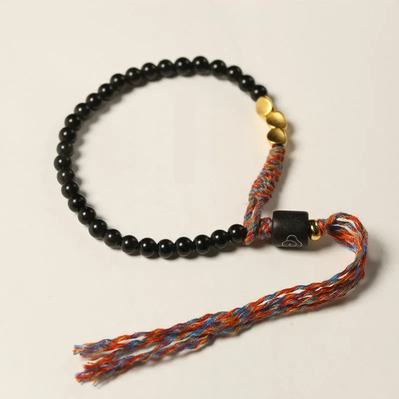 Hand-woven obsidian carrying strap bracelet showing 4mm width and adjustable length