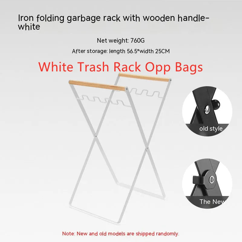 Folding black outdoor trash bag hanger with wooden carry handle on a patio.