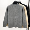 Men's black zip-up knitted cardigan with a stand collar on a hanger