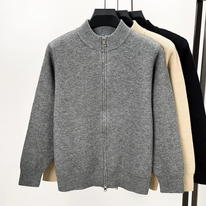 Men's black zip-up knitted cardigan with a stand collar on a hanger