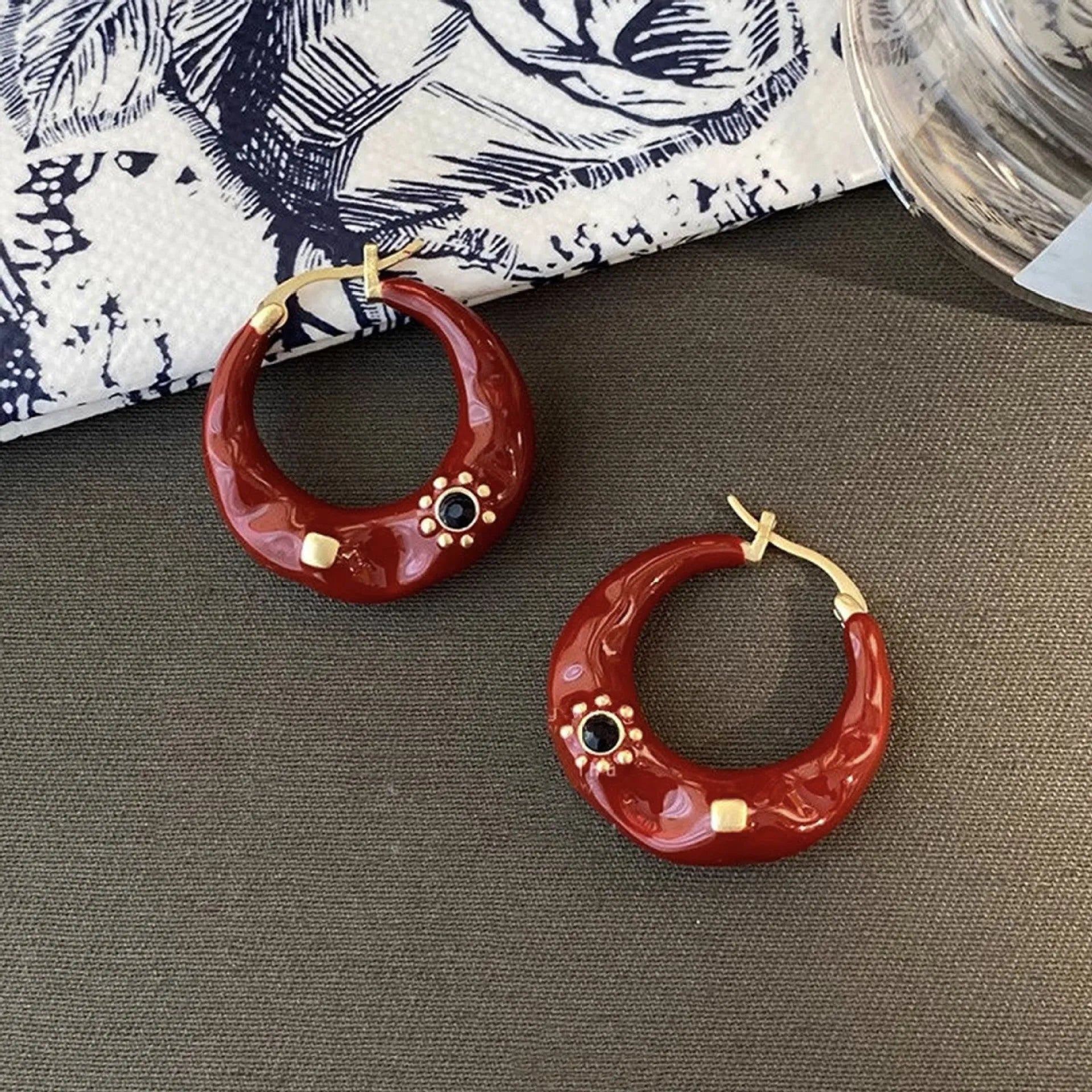 Hong Kong style retro ear studs with dripping oil finish and rhinestone detail in black and red colours