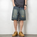 Men's blue denim shorts with loose hole distressing and straight leg silhouette