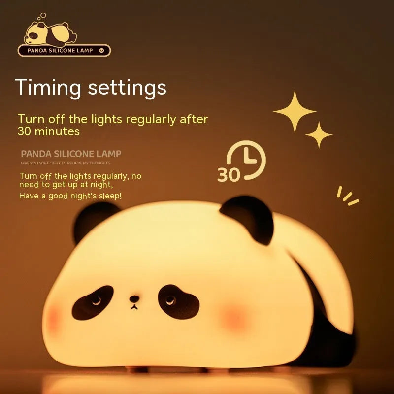 Panda shaped silicone night light with warm white glow on dark surface