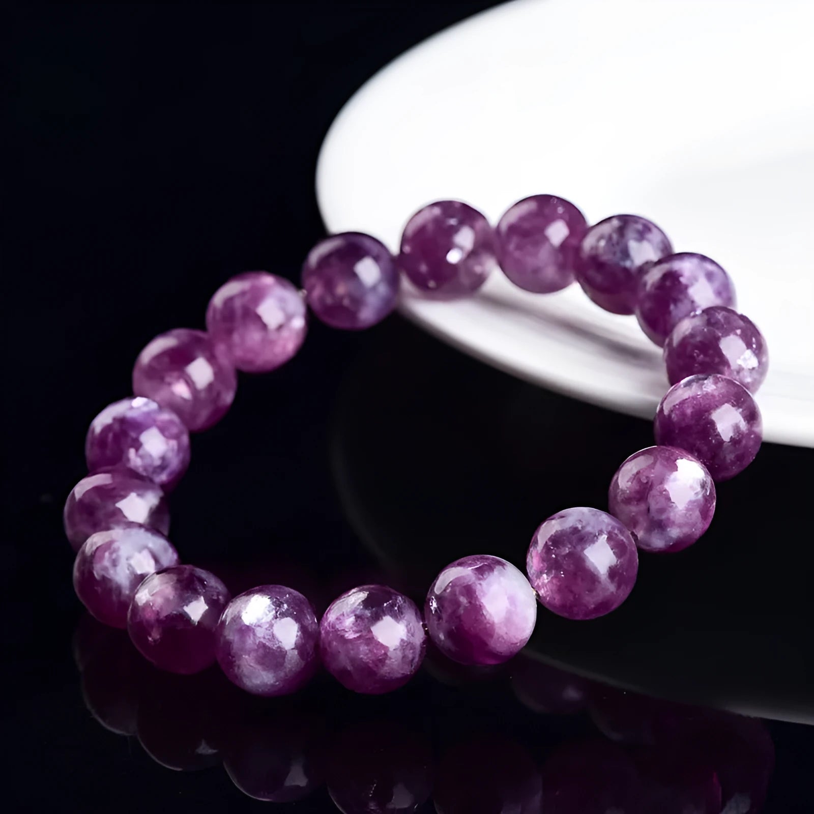 Grandmother Crystal bracelet with purple geometry-shaped beads on a wrist.