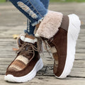 Women's beige lace-up snow boots with suede upper, thick rubber sole, and decorative stitching