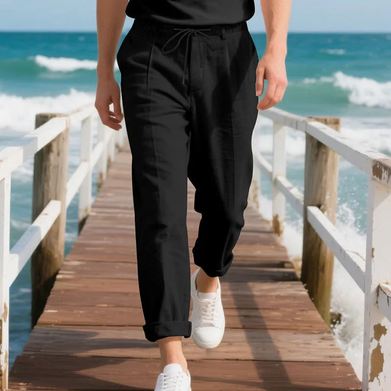 Men's light beige linen casual trousers with drawstring waist and straight-leg fit on a hanger.