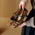 Women's black square toe stiletto ankle-strap heels with a horse hair upper.