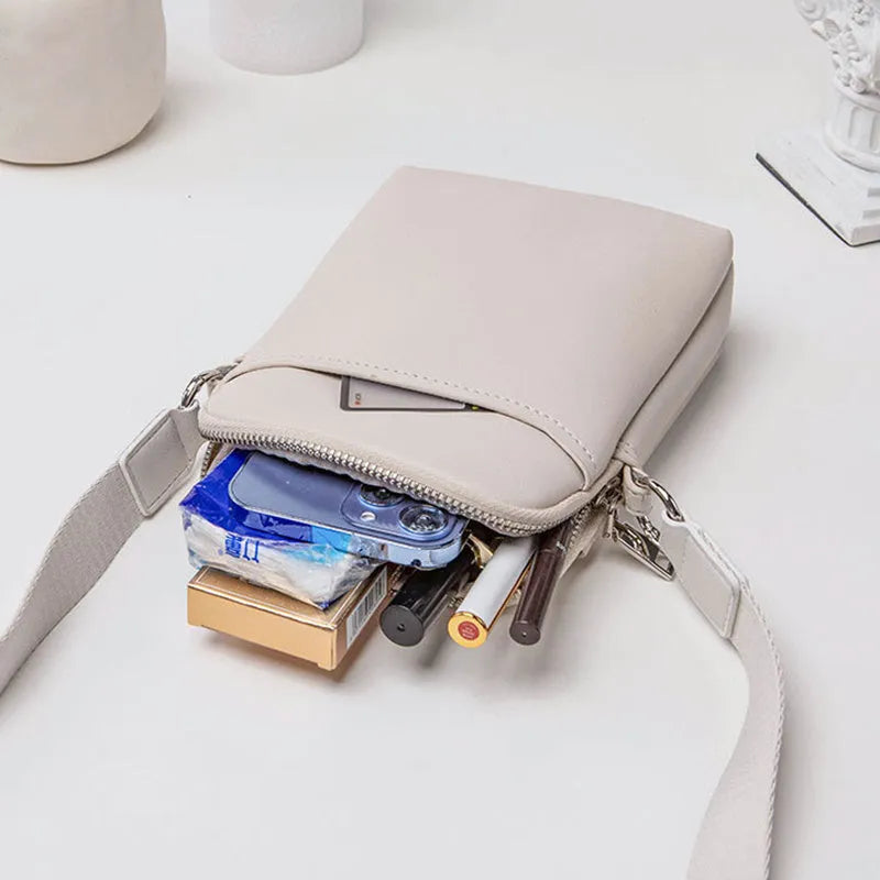 Solid colour small crossbody shoulder bag in PU leather measuring 14.5cm by 5.5cm by 19cm