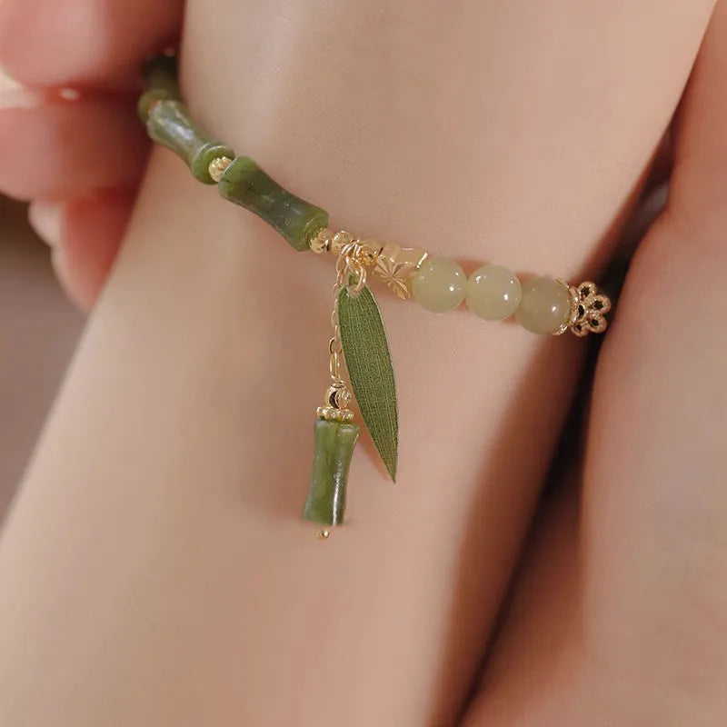Handmade Chinese style glass bracelet with bamboo joint beads in a red Lvzhu Duobao design.