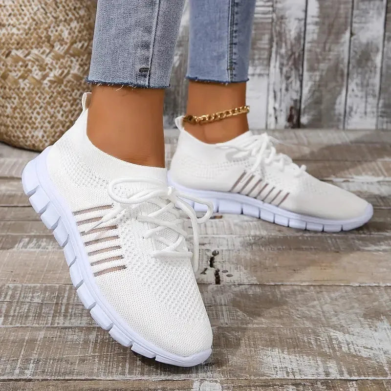 Women's casual breathable mesh flat shoes in pink with front tie and low heel on a light background.