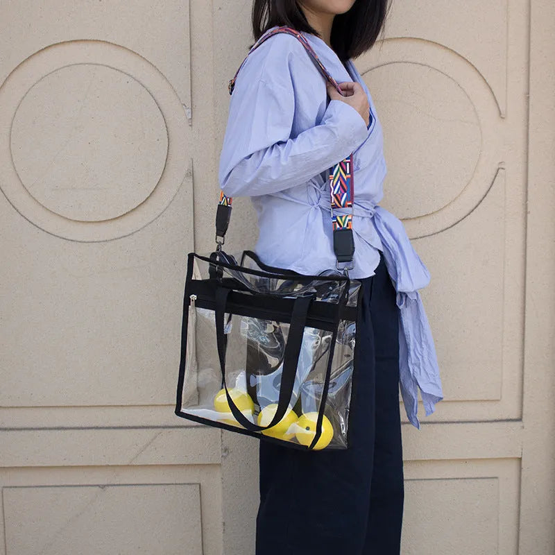 Women's transparent PVC messenger bag with crossbody strap and three-dimensional front pocket.