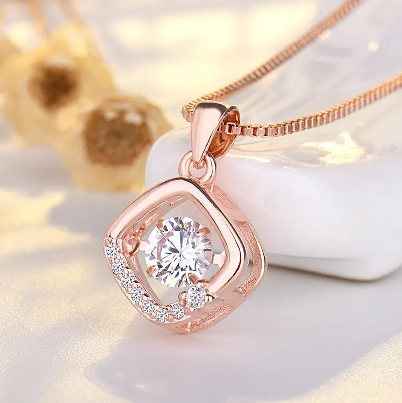 Heart-shaped pendant necklace with crown and bow design in rose gold or silver finish