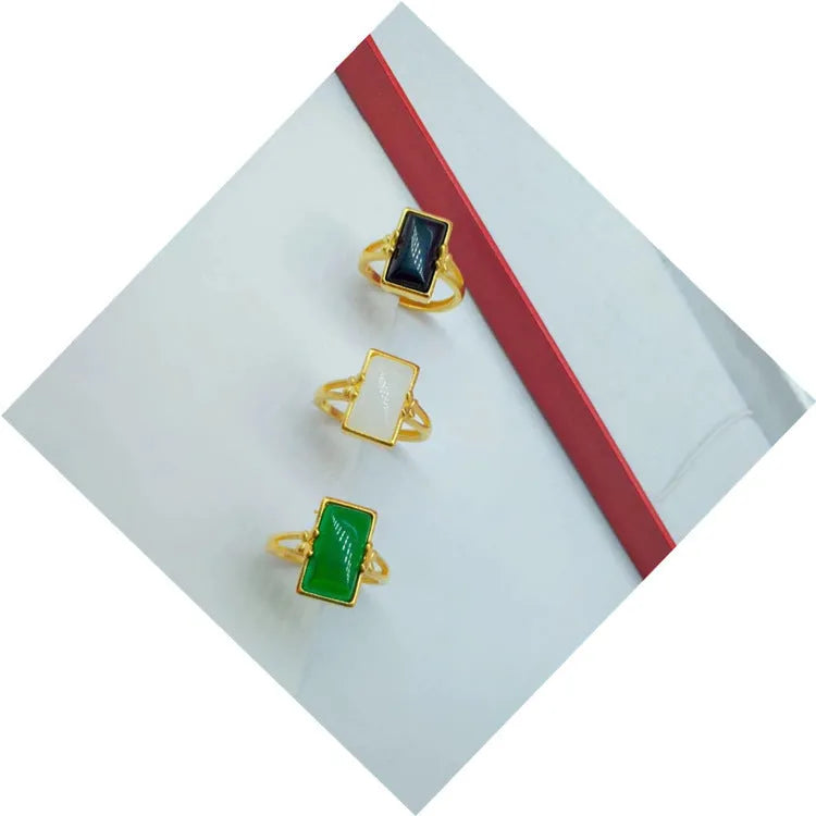 Adjustable brass gold-plated ring with gemstone in green, white or black options showing adjustable port mechanism
