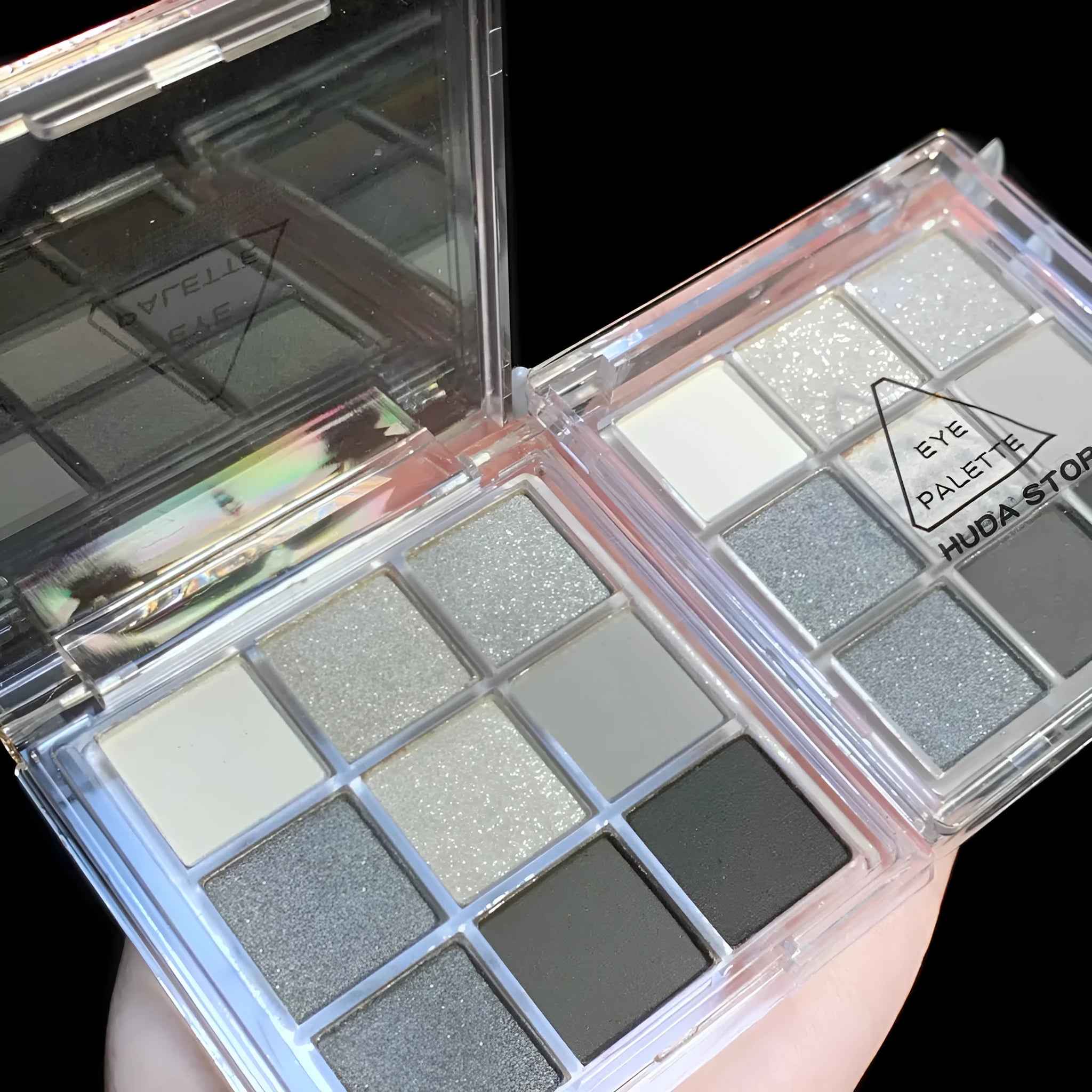 Smoked design nine-colour eyeshadow palette showing shades of white, silver, black, and iron grey.