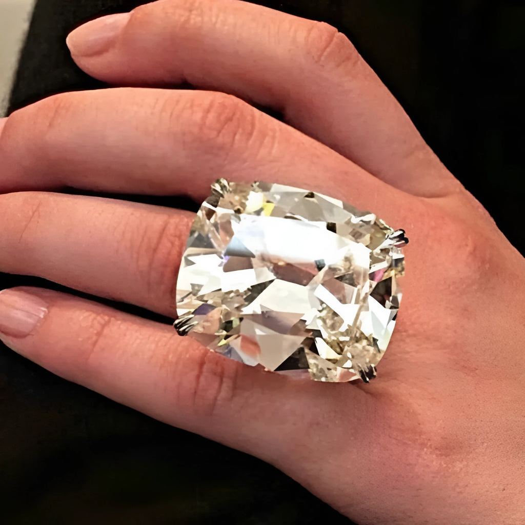 Simple inlaid white square diamond ring on a geometric alloy band with a white gold colour finish.