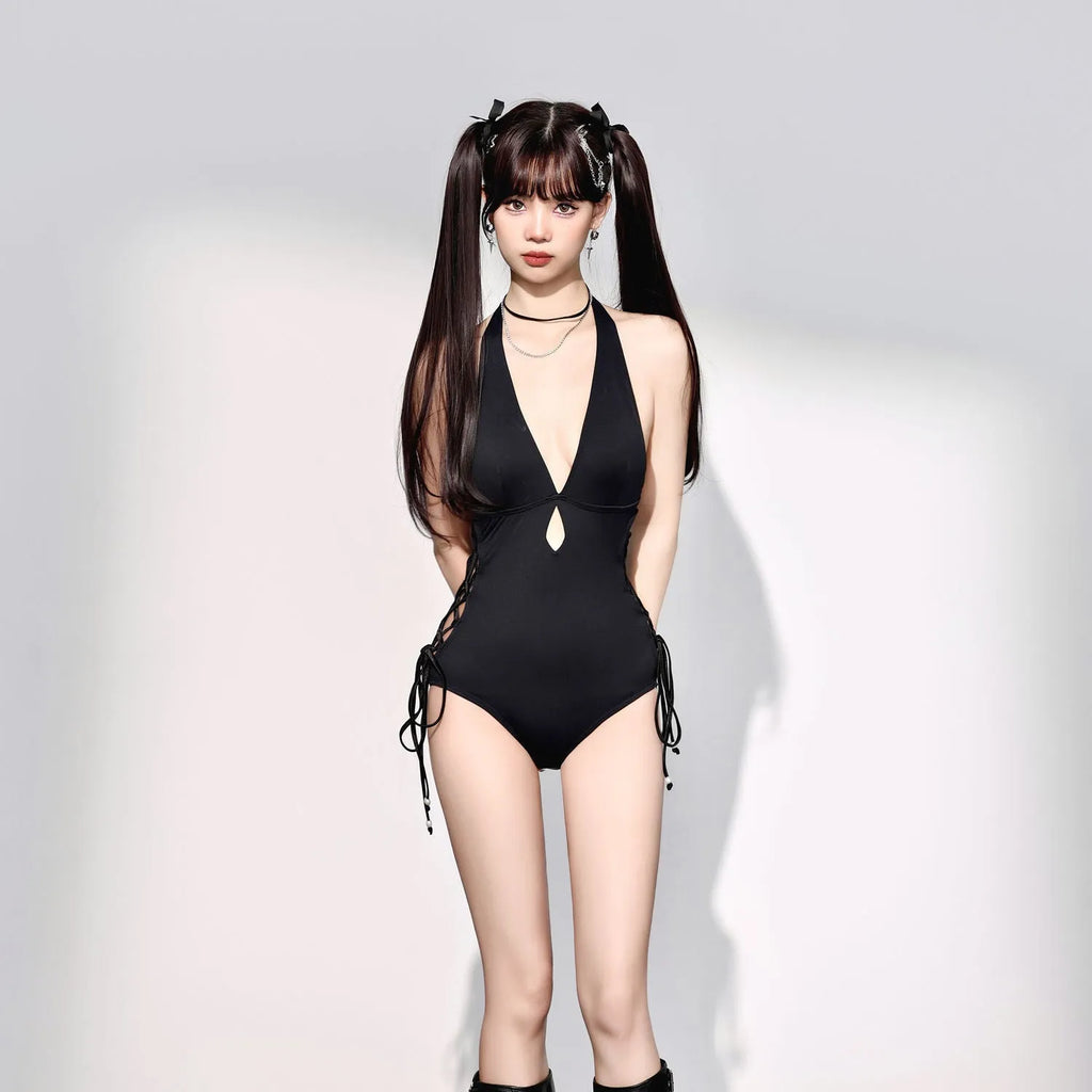 Women's V-neck hollow strap one-piece swimsuit in black, front view, shown on a model