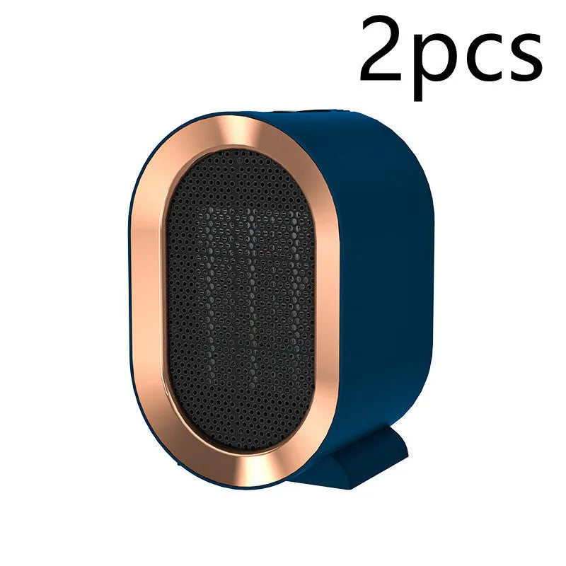 Compact black desktop electric fan heater with mechanical control dials and a safety grille.