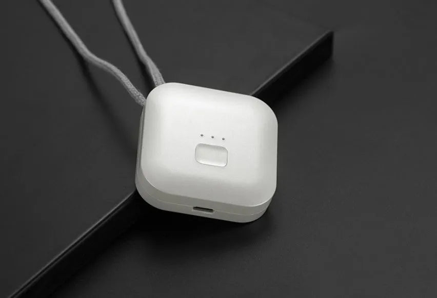 Mini USB portable air purifier necklace in pink, showing compact wearable design.