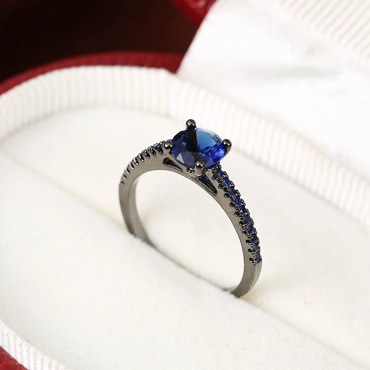 Geometric hexagon copper ring with colourful zircon stones in a metallic electroplated finish.