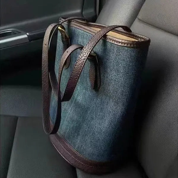 Blue denim patchwork one-shoulder bucket handbag with a large opening.