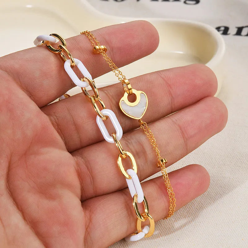Ins style stainless steel and resin bracelet with a double-layered heart charm.