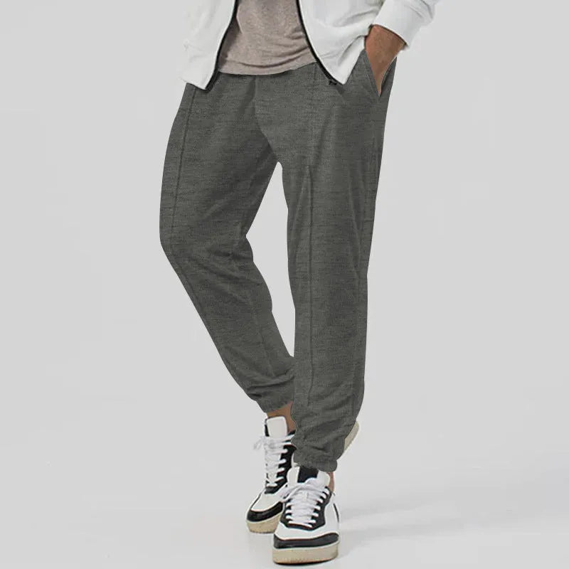 Men's gray elastic track sweatpants with straight-leg tapered design and mid waist