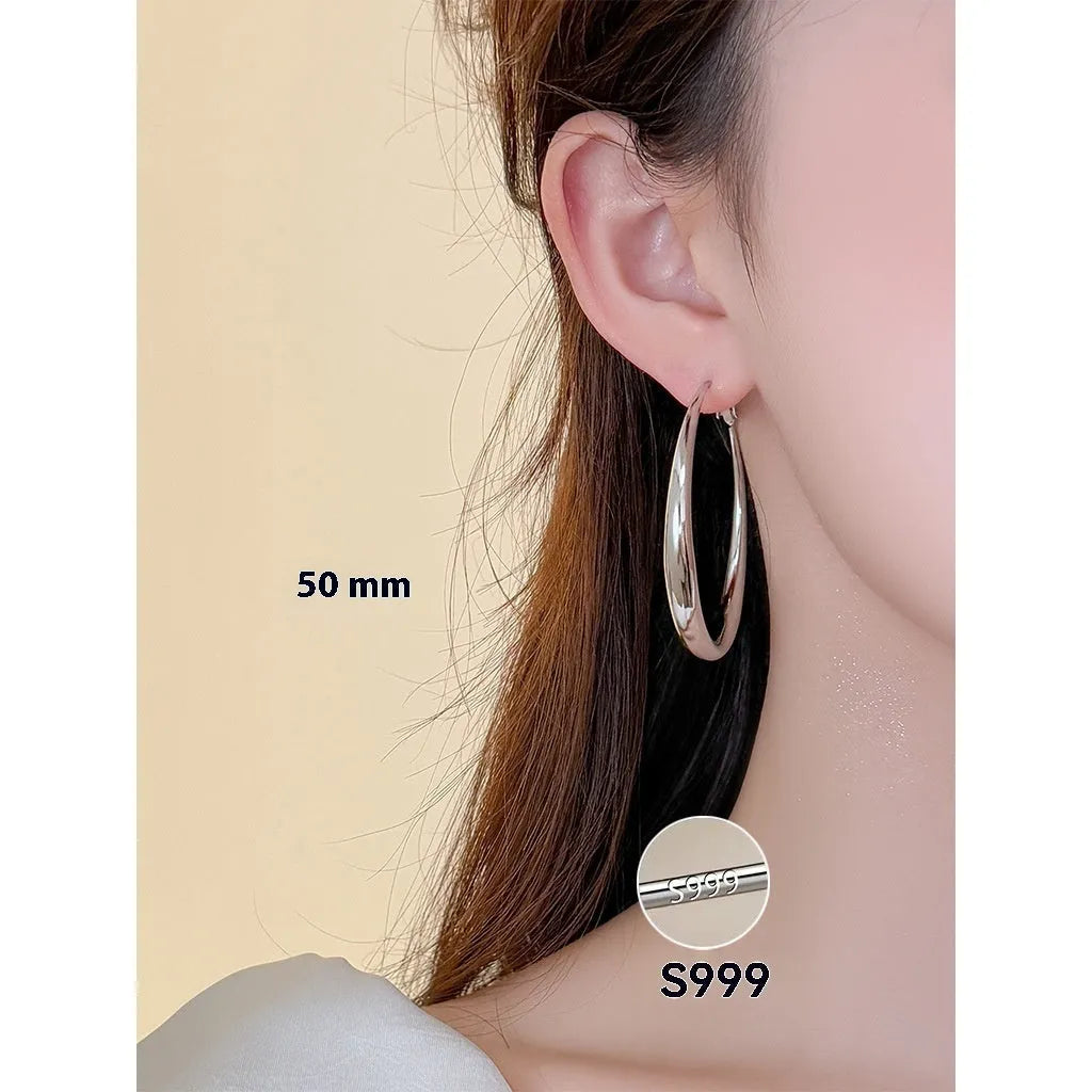 Silver needle big circle bracelet and earrings set with electroplated platinum finish on light background, three size options