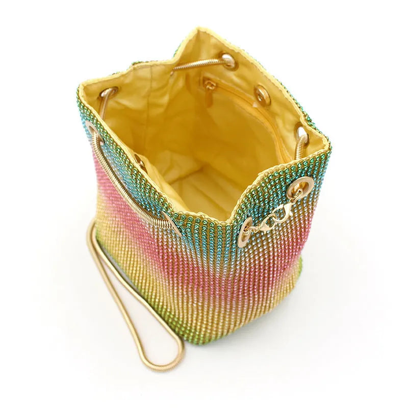 Rhinestone bucket bag with sparkling coverage and adjustable shoulder straps