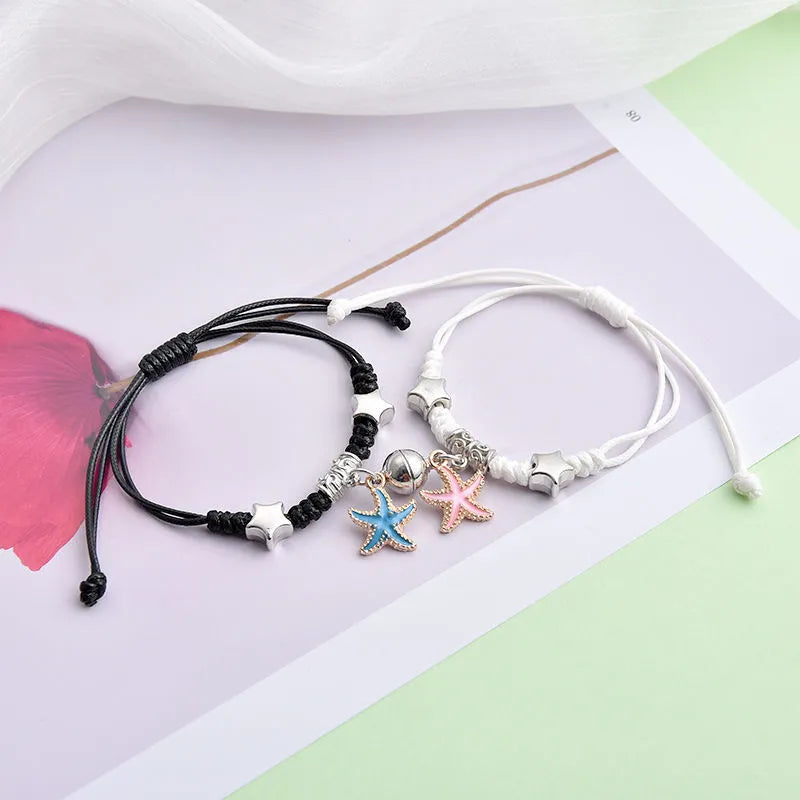 Magnetic couple bracelet pair with alloy electroplating in various designs including clover and crown patterns