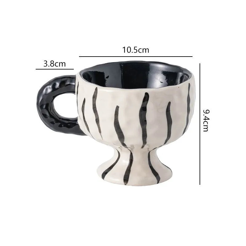 Hand-pinched irregular ceramic mug with modern minimalist design in solid colour
