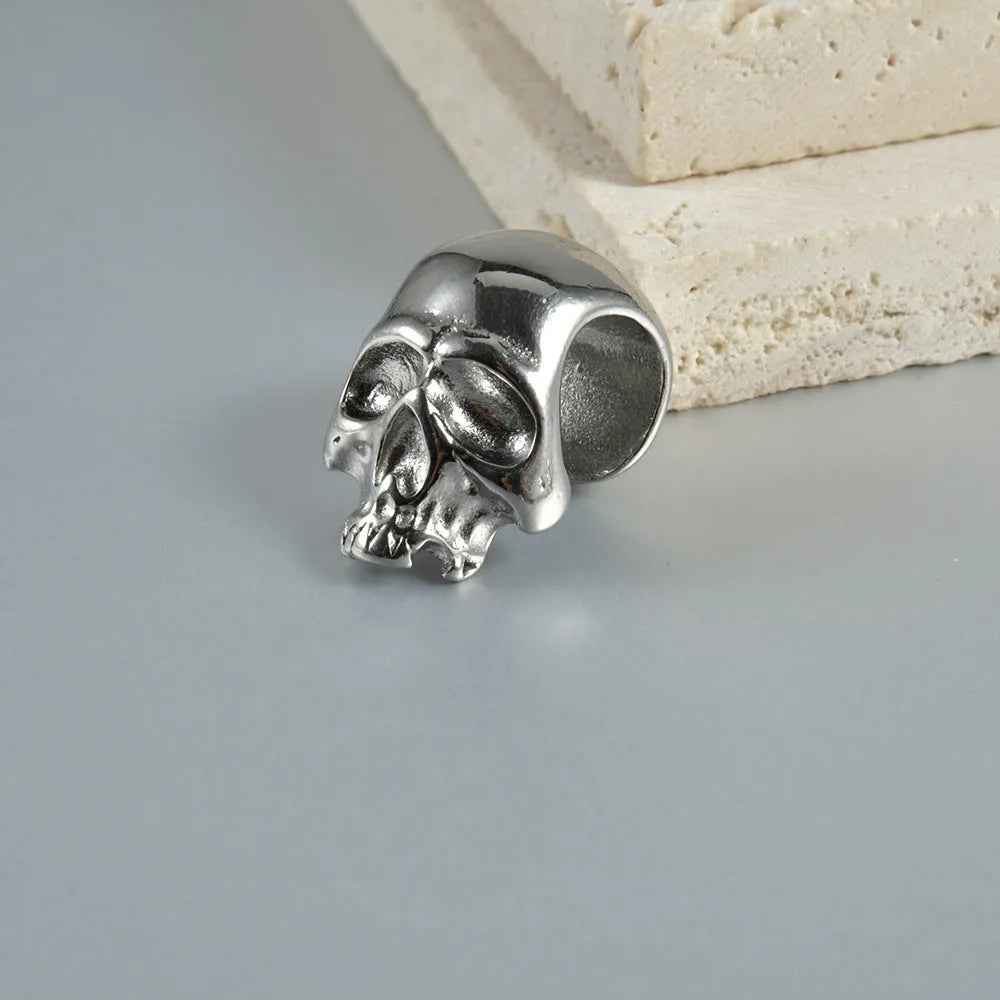 Geometric stainless steel earrings combining hollow skull and Buddha motifs with electroplated finish