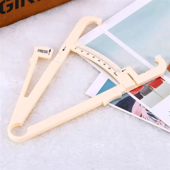 Acrylic body fat caliper with measurement scale showing 0.001mm accuracy