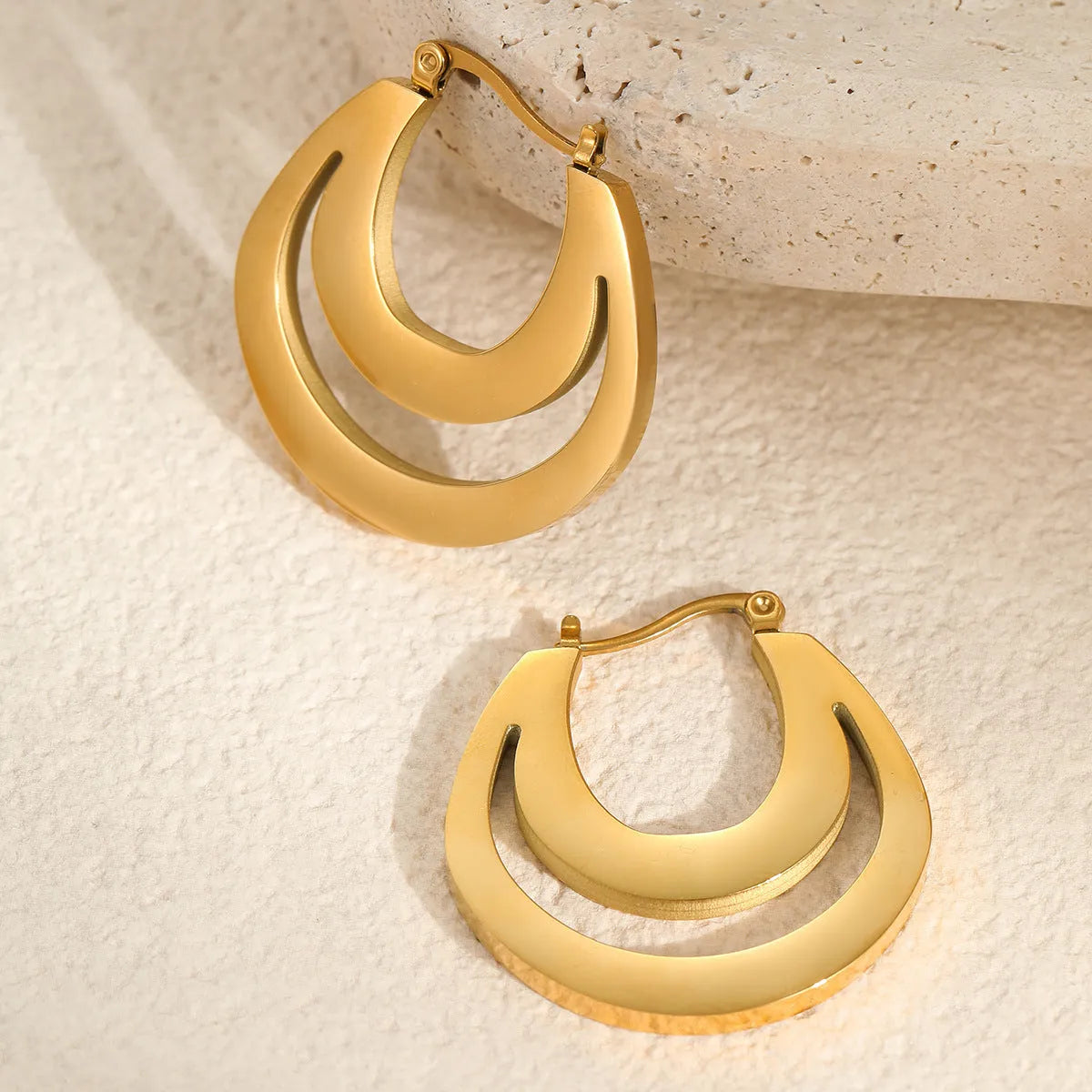 Geometric French earrings with circular ring elements in 18K gold plated metallic finish