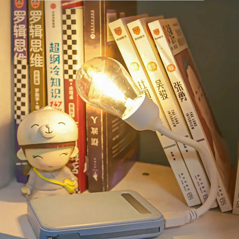 A folding USB rechargeable night light with a glowing tungsten filament S14 LED bulb.