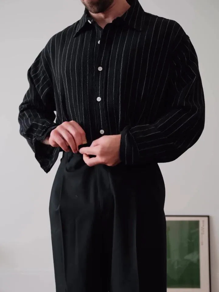 Black pinstriped button-down men's shirt with striped pattern on polyester fabric