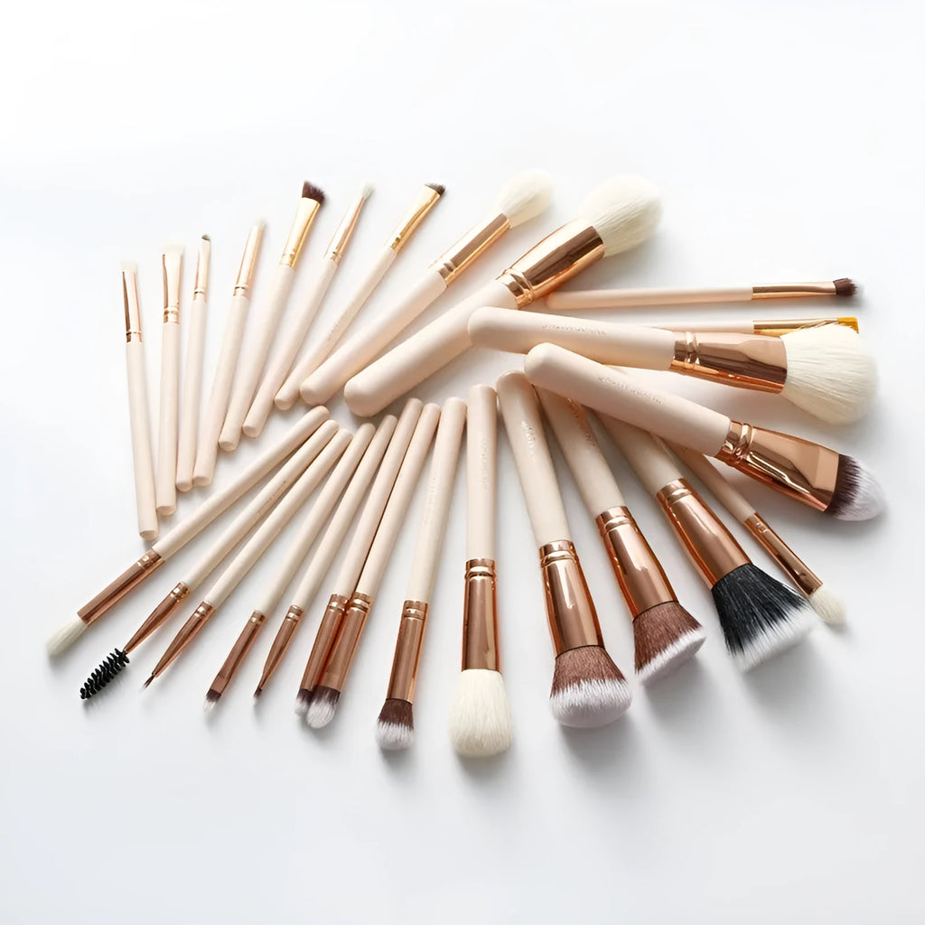 26 pink makeup brushes with wood handles arranged in a PU travel pouch.
