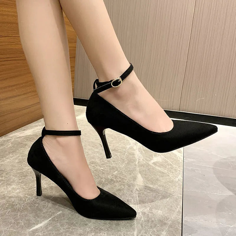 Women's black buckle stiletto pump heel shoe with 8cm heel and rubber sole.