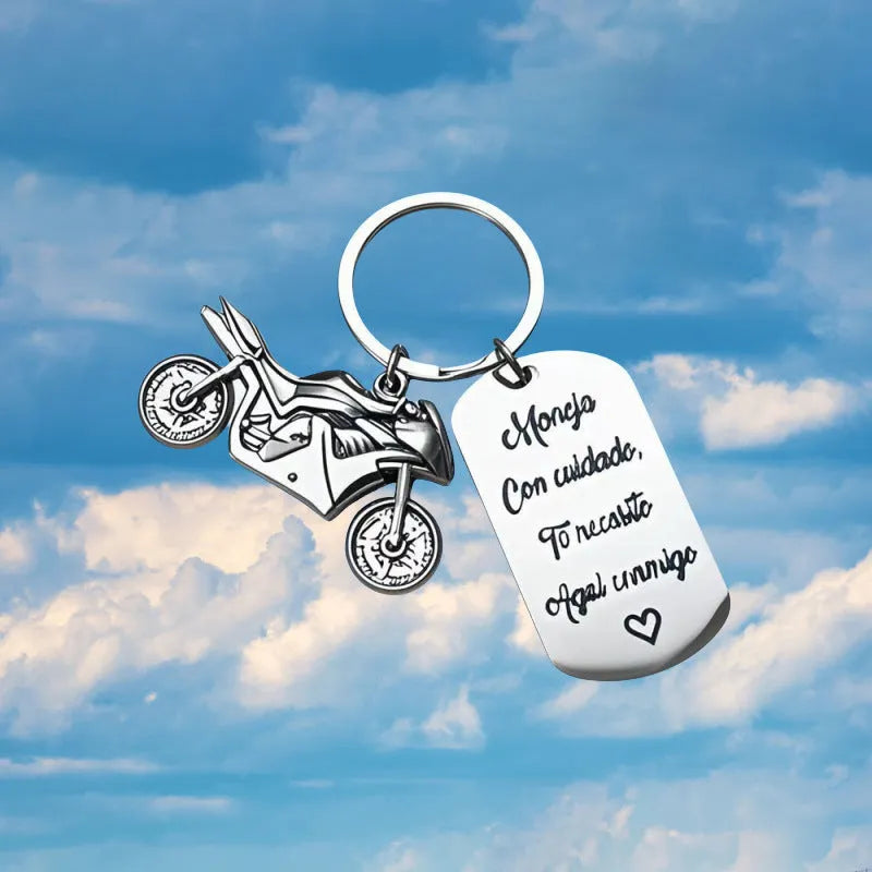 Stainless steel key ring with detailed motorcycle design on metal surface