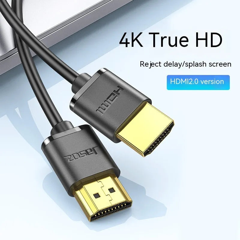 Thin flexible HDMI video cable with gold-plated connectors on a white background.