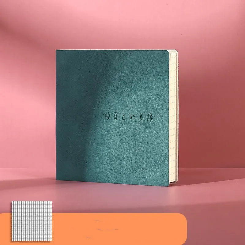 Square A5 mesh leather notebook in avocado green with French fold binding open on blank pages