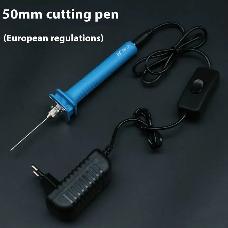 Blue plastic-handled electric foam cutter pen with adapter on a work surface.