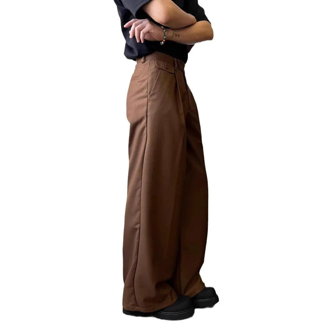 Man wearing straight-leg loose fit casual trousers in brown, showcasing the drape and fit.