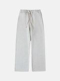 Man wearing black fleece-lined loose-fit sweatpants with an elastic drawstring waist