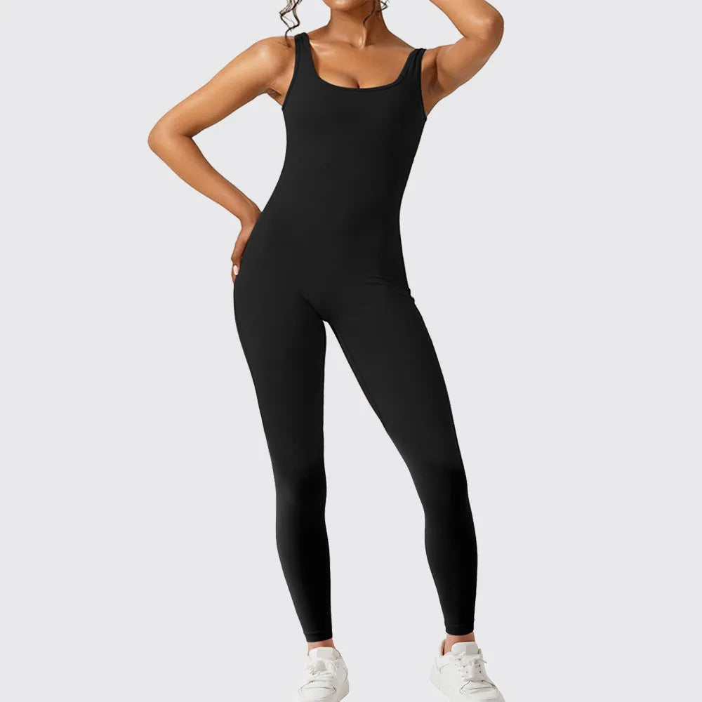 Woman wearing a sleeveless flare-leg jumpsuit for yoga in Army Green, showcasing the fashionable waist and full length.