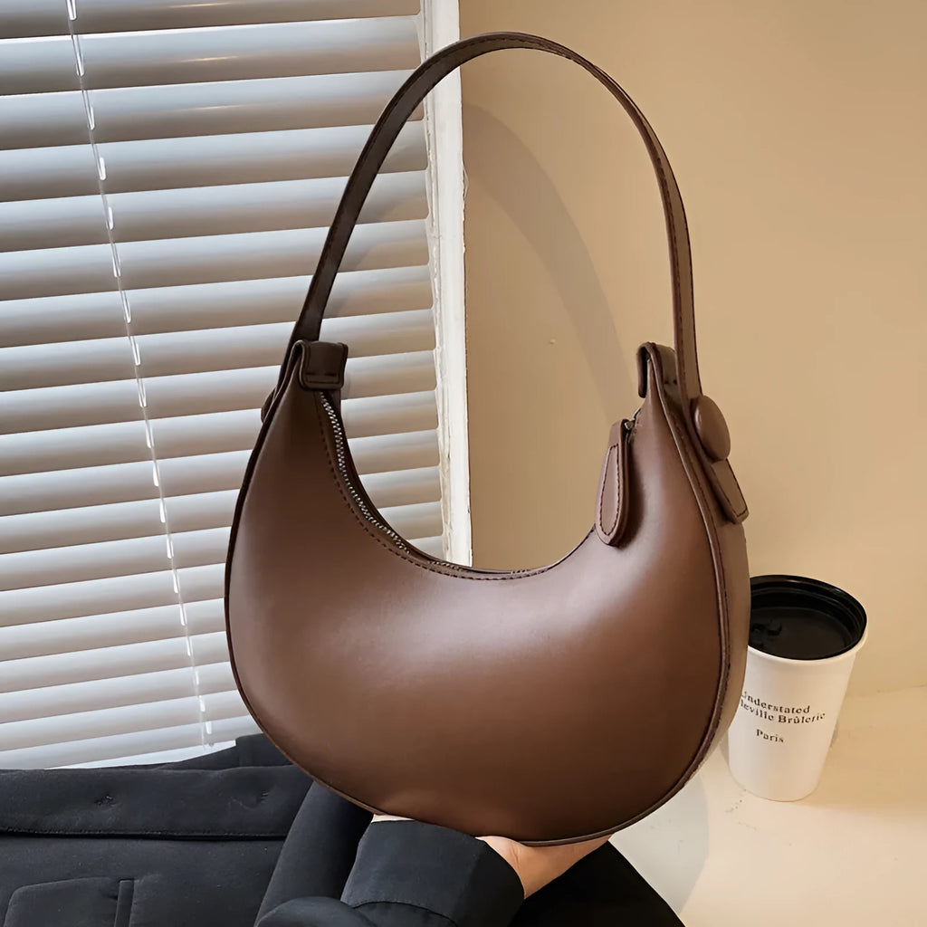 Women's cream yellow retro dumpling-shaped PU leather shoulder bag showing front and internal zippered pocket.