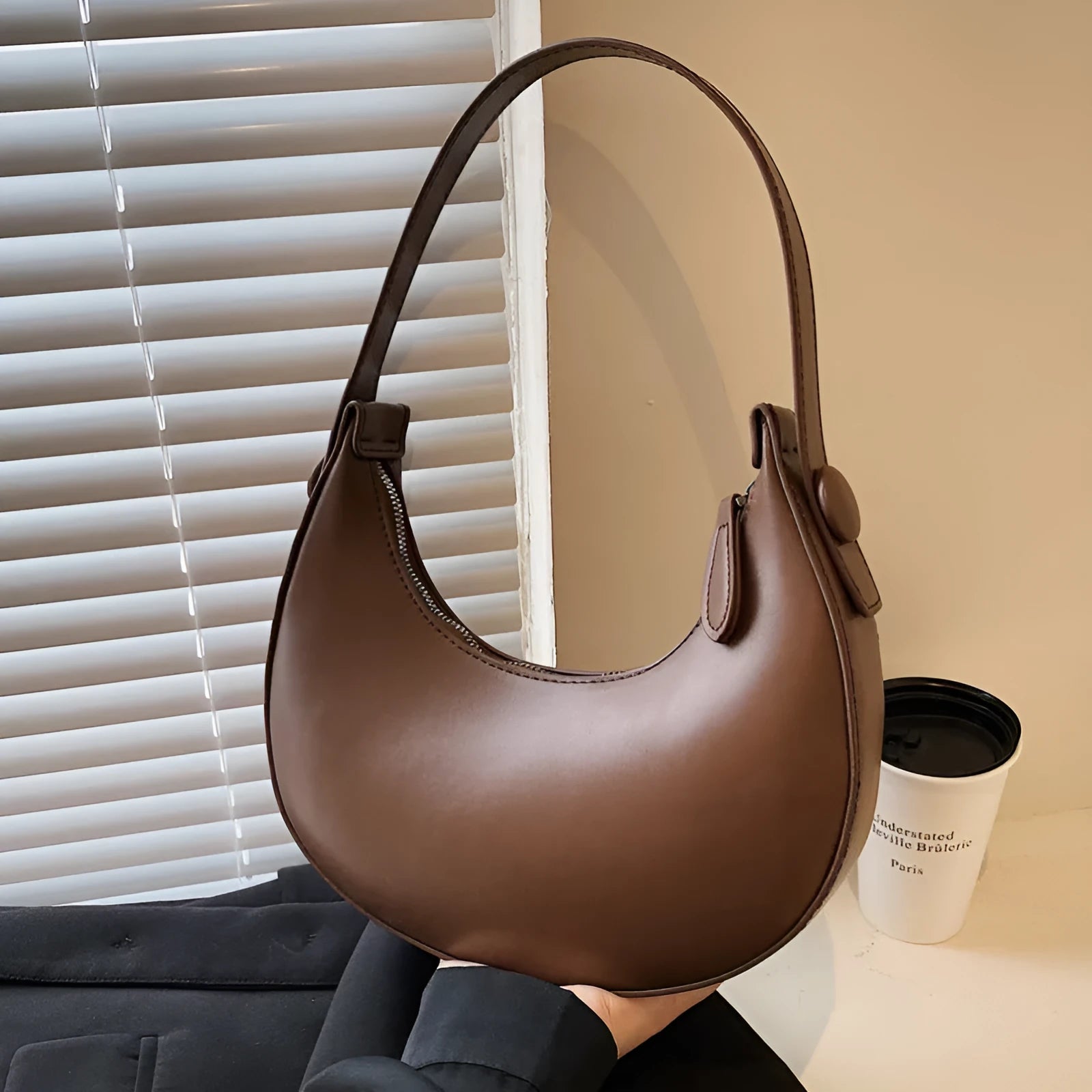 Women's cream yellow retro dumpling-shaped PU leather shoulder bag showing front and internal zippered pocket.